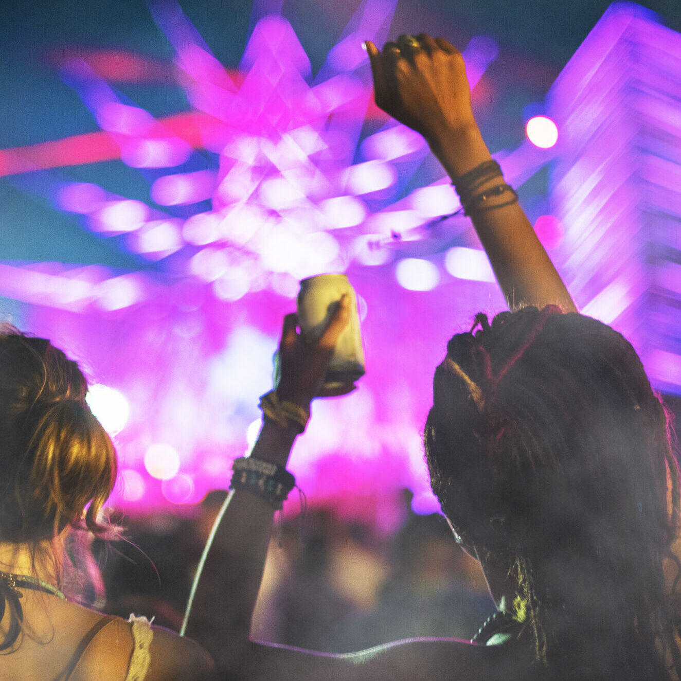 People at concert with smoke overlay texture